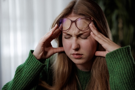 woman headache at home