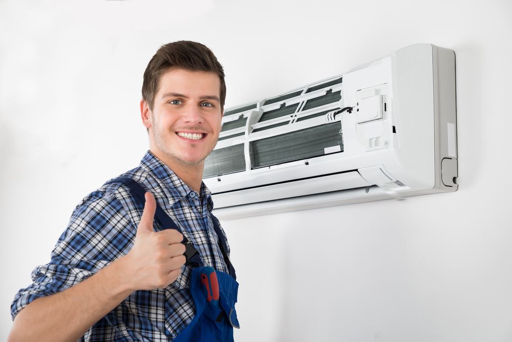 Technician thumbs up after performing AC repair