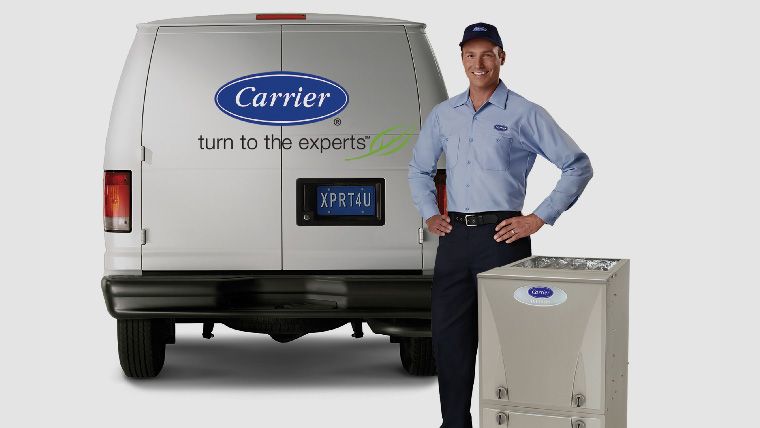 Service technician standing by Carrier van and AC unit
